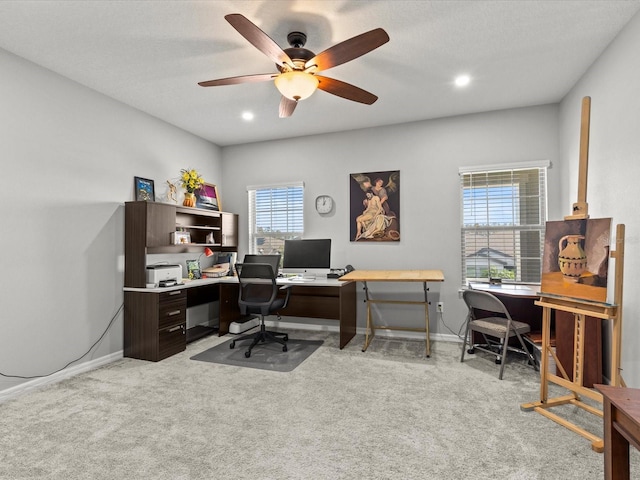 carpeted home office featuring ceiling fan and a textured ceiling