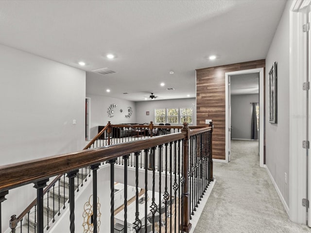 hallway featuring light colored carpet