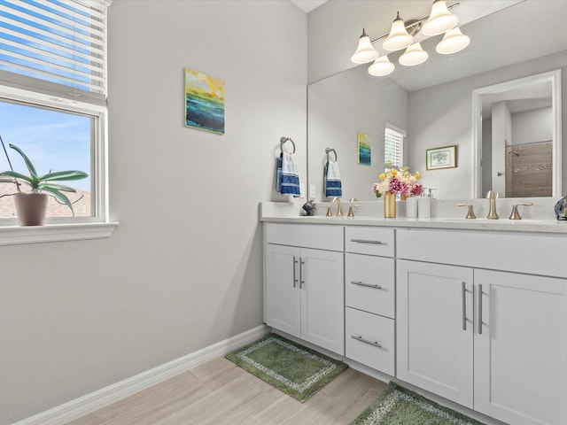 bathroom featuring vanity, wood-type flooring, and walk in shower