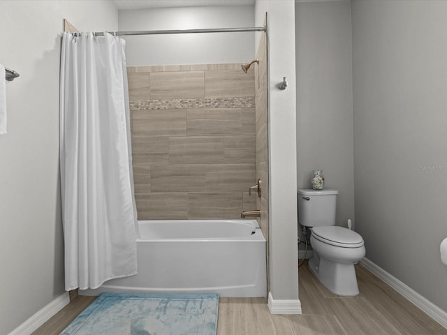 bathroom with wood-type flooring, toilet, and shower / bath combo with shower curtain