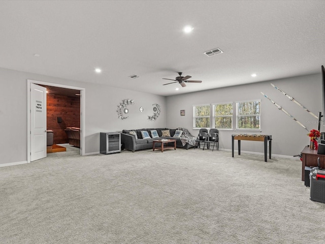 unfurnished living room with light colored carpet and ceiling fan