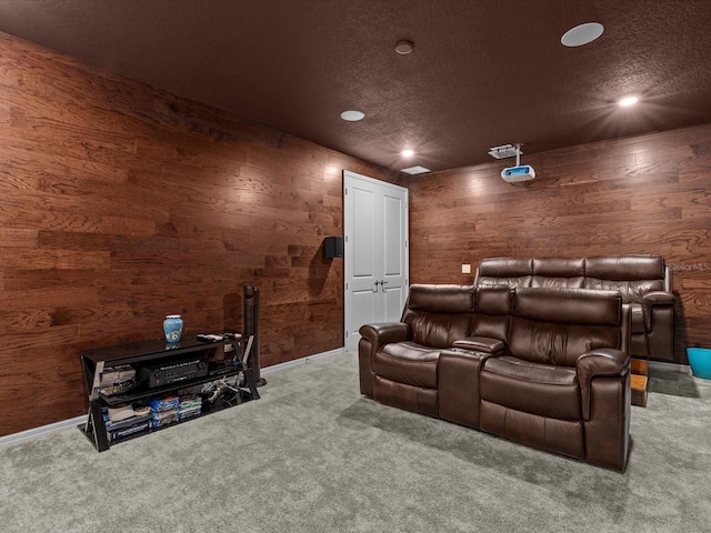 home theater room with carpet and a textured ceiling