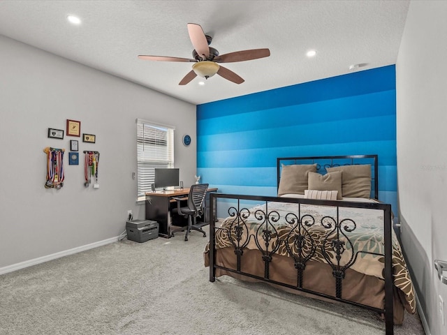 carpeted bedroom featuring a textured ceiling and ceiling fan