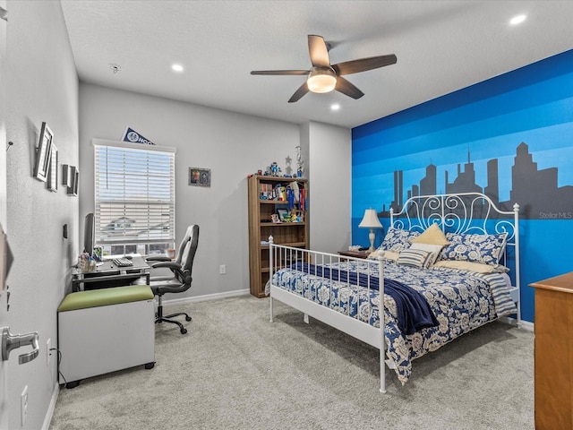 carpeted bedroom with ceiling fan and a textured ceiling