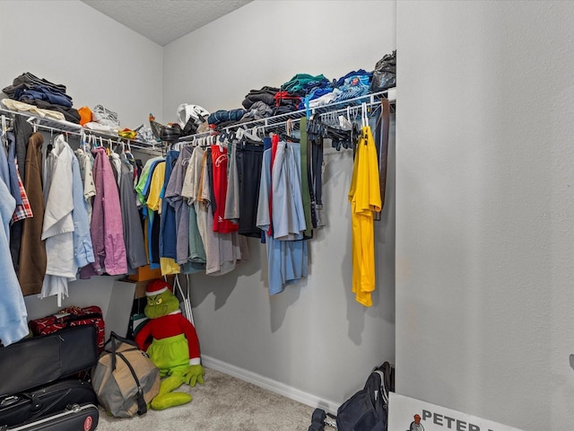 walk in closet with carpet flooring