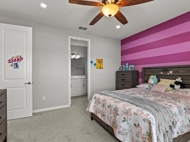 bedroom with carpet, connected bathroom, and ceiling fan