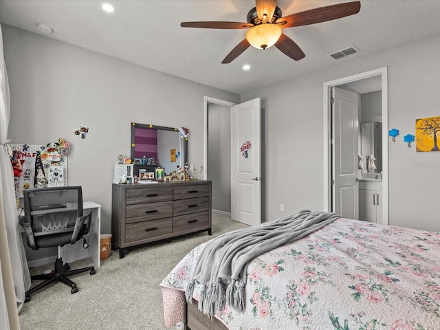 carpeted bedroom featuring connected bathroom and ceiling fan