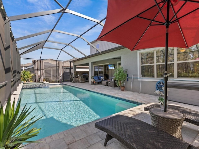 view of pool featuring a lanai, ceiling fan, and a patio area