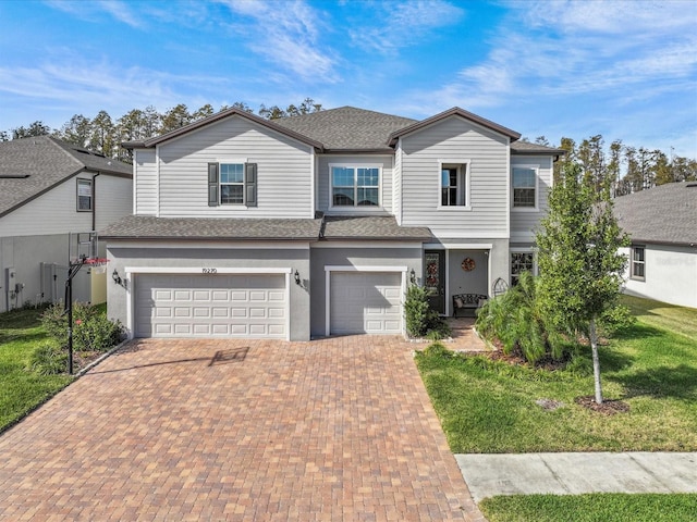 front facade with a front lawn and a garage