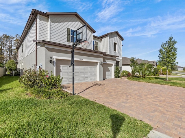 view of front of property with a front yard and a garage