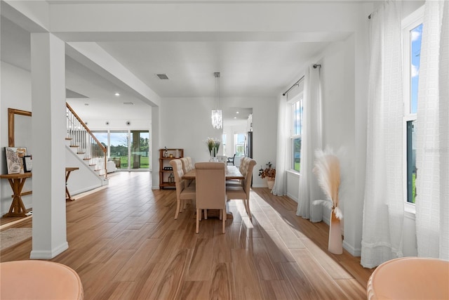 dining area featuring a wealth of natural light and a notable chandelier