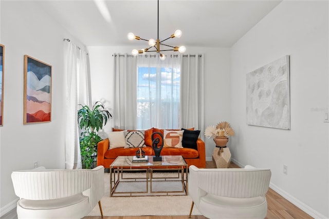 living room with a notable chandelier and light hardwood / wood-style floors