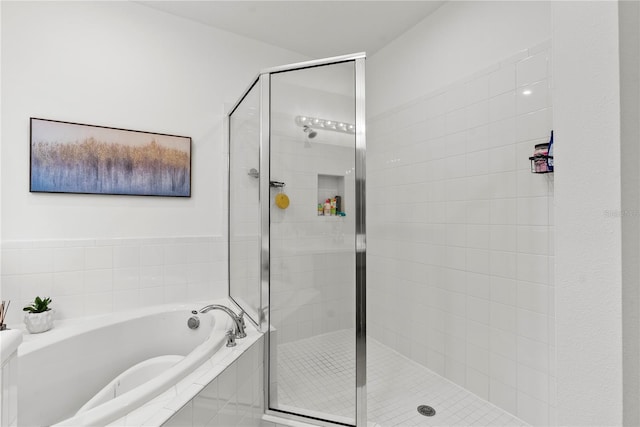 bathroom with shower with separate bathtub