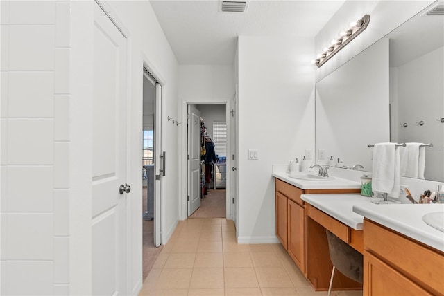 bathroom with tile patterned floors and vanity