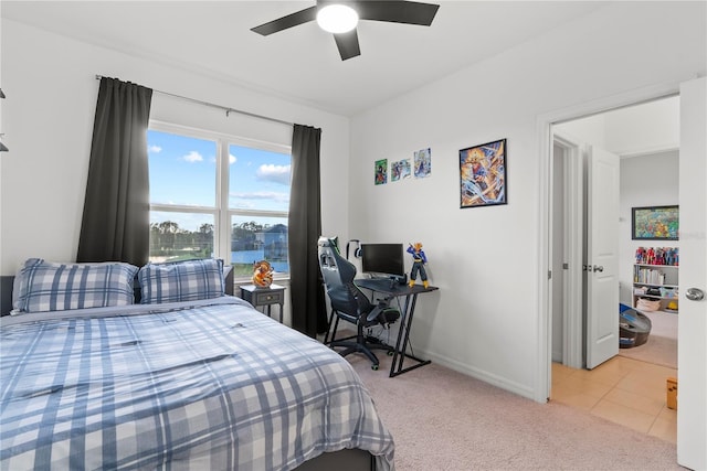bedroom featuring light colored carpet, baseboards, and ceiling fan