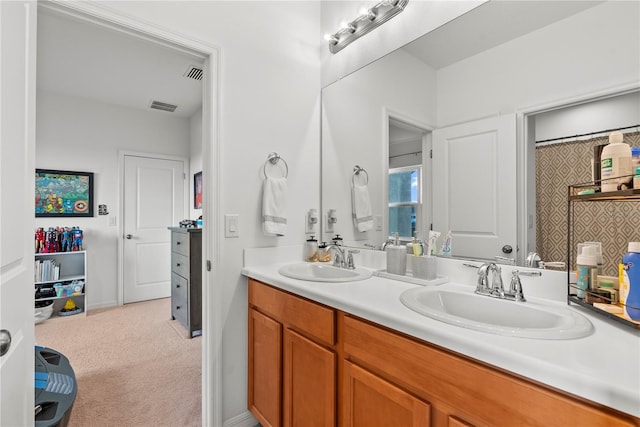 bathroom with a sink, double vanity, and visible vents