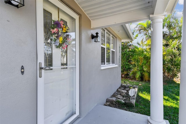 property entrance featuring stucco siding