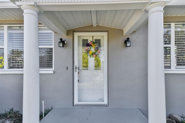 property entrance featuring stucco siding