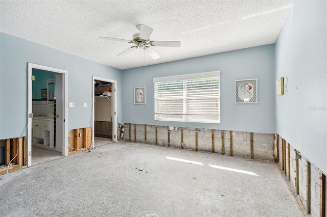 spare room with a textured ceiling and ceiling fan