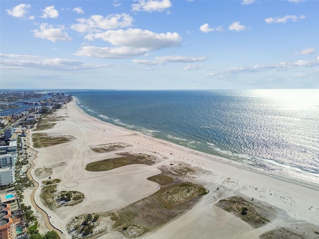 aerial view with a water view and a beach view