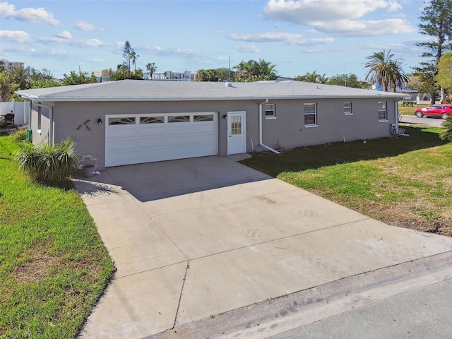 single story home with stucco siding, driveway, a garage, and a front yard