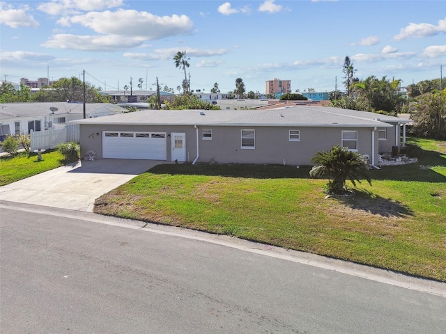 single story home featuring stucco siding, driveway, an attached garage, and a front lawn