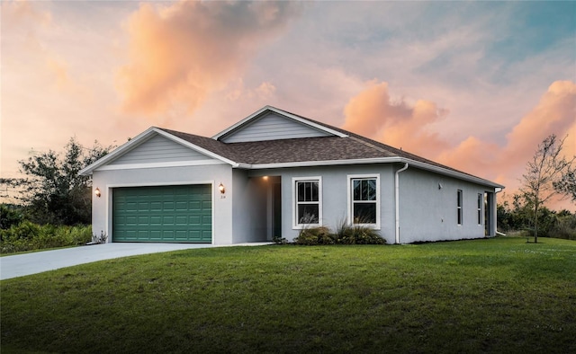 ranch-style house featuring a lawn and a garage