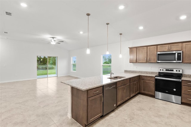 kitchen featuring kitchen peninsula, stainless steel appliances, vaulted ceiling, sink, and pendant lighting