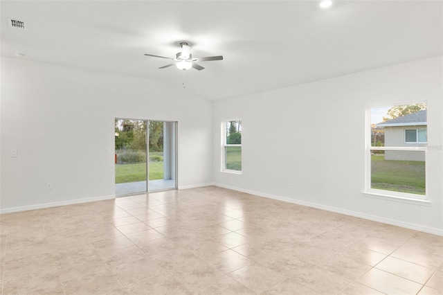 tiled spare room featuring ceiling fan, a wealth of natural light, and vaulted ceiling