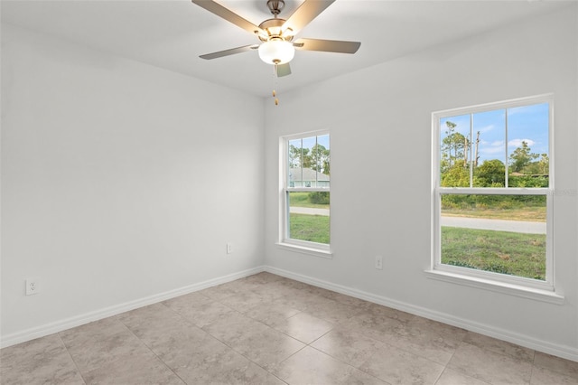 tiled empty room with plenty of natural light and ceiling fan