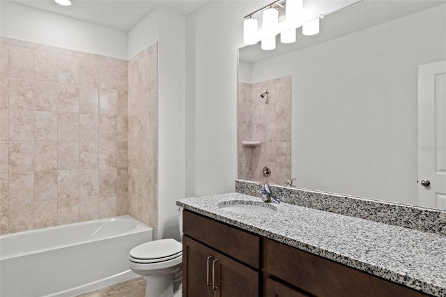 full bathroom featuring tiled shower / bath combo, toilet, and vanity