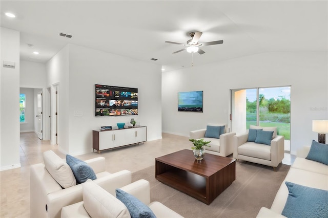 living room featuring ceiling fan, light tile patterned flooring, and vaulted ceiling