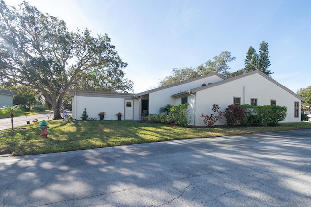 ranch-style house with a front lawn