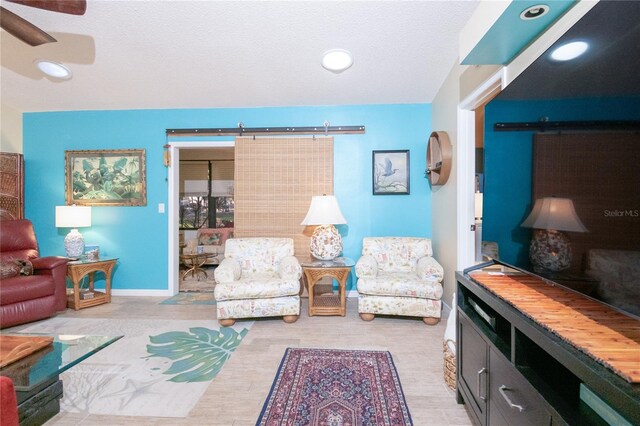 sitting room featuring ceiling fan and light wood-type flooring