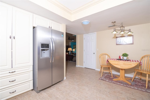 kitchen with stainless steel refrigerator with ice dispenser, white cabinetry, ornamental molding, and ceiling fan