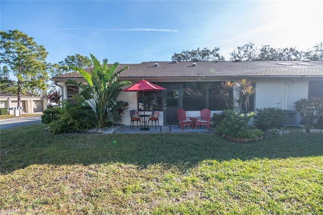 rear view of house with a yard and a patio area