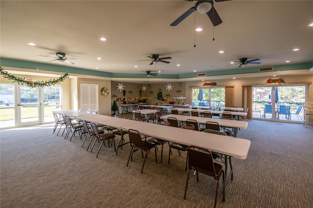 dining space with carpet floors and ceiling fan