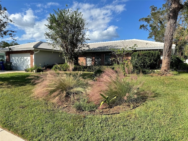 single story home featuring a garage and a front yard