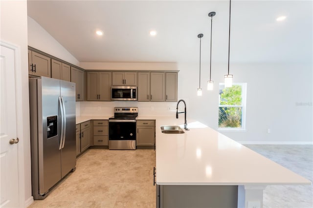 kitchen featuring lofted ceiling, sink, decorative backsplash, appliances with stainless steel finishes, and decorative light fixtures