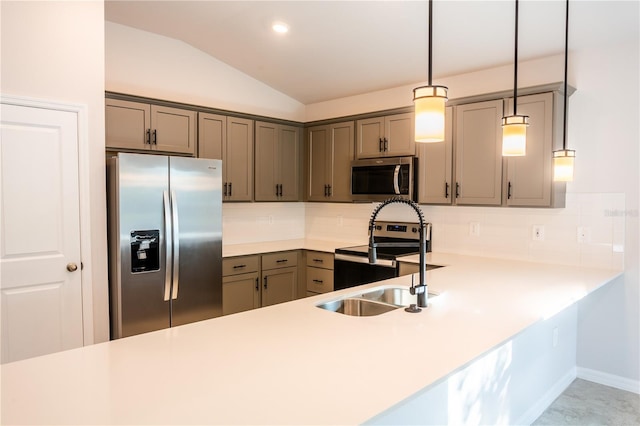 kitchen with kitchen peninsula, appliances with stainless steel finishes, decorative backsplash, vaulted ceiling, and pendant lighting