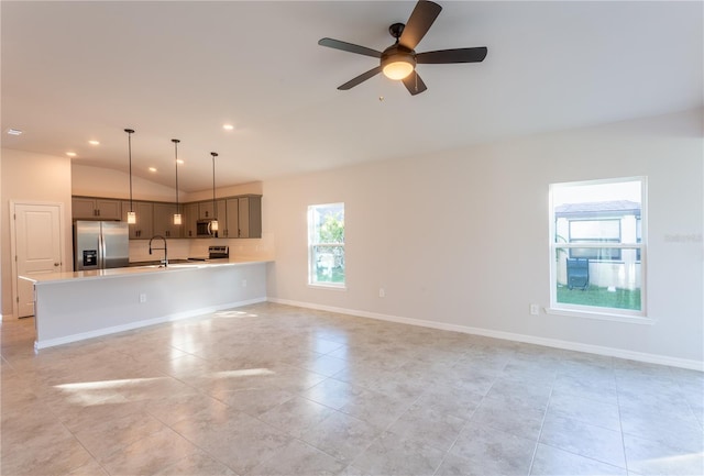 133 Angol St, Punta Gorda, FL 33983 - unfurnished living room featuring vaulted ceiling, a sink, ceiling fan, light tile patterned flooring, and baseboards