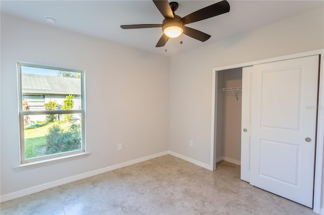 unfurnished bedroom featuring ceiling fan and a closet