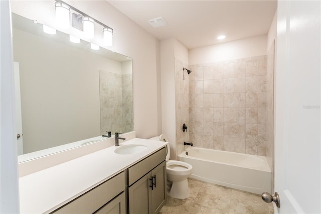 full bathroom with vanity, tiled shower / bath combo, and toilet