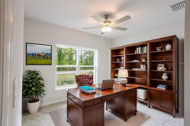 tiled home office featuring ceiling fan