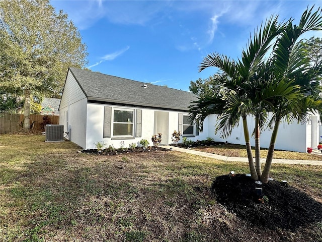 view of front facade with a front yard and central AC