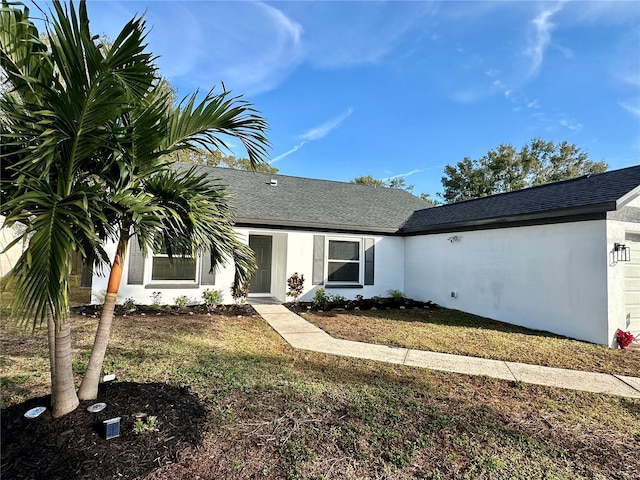 single story home featuring a garage, a shingled roof, and stucco siding