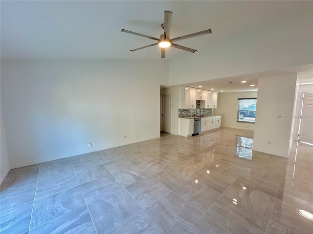 unfurnished living room featuring a ceiling fan, marble finish floor, high vaulted ceiling, and baseboards