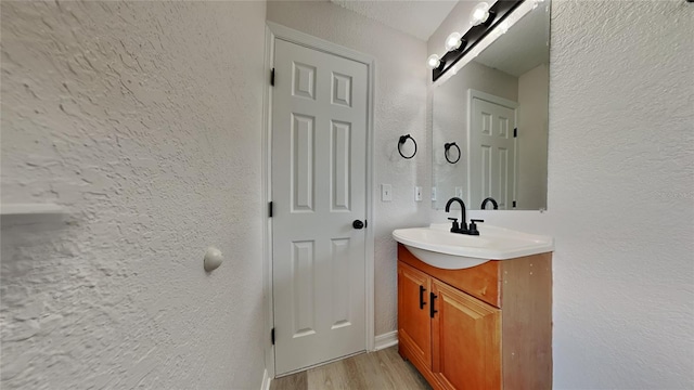 bathroom featuring vanity and hardwood / wood-style flooring