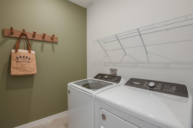 laundry room with light tile patterned flooring and washing machine and clothes dryer