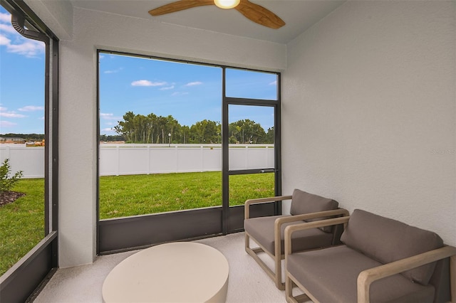 sunroom featuring ceiling fan and a healthy amount of sunlight